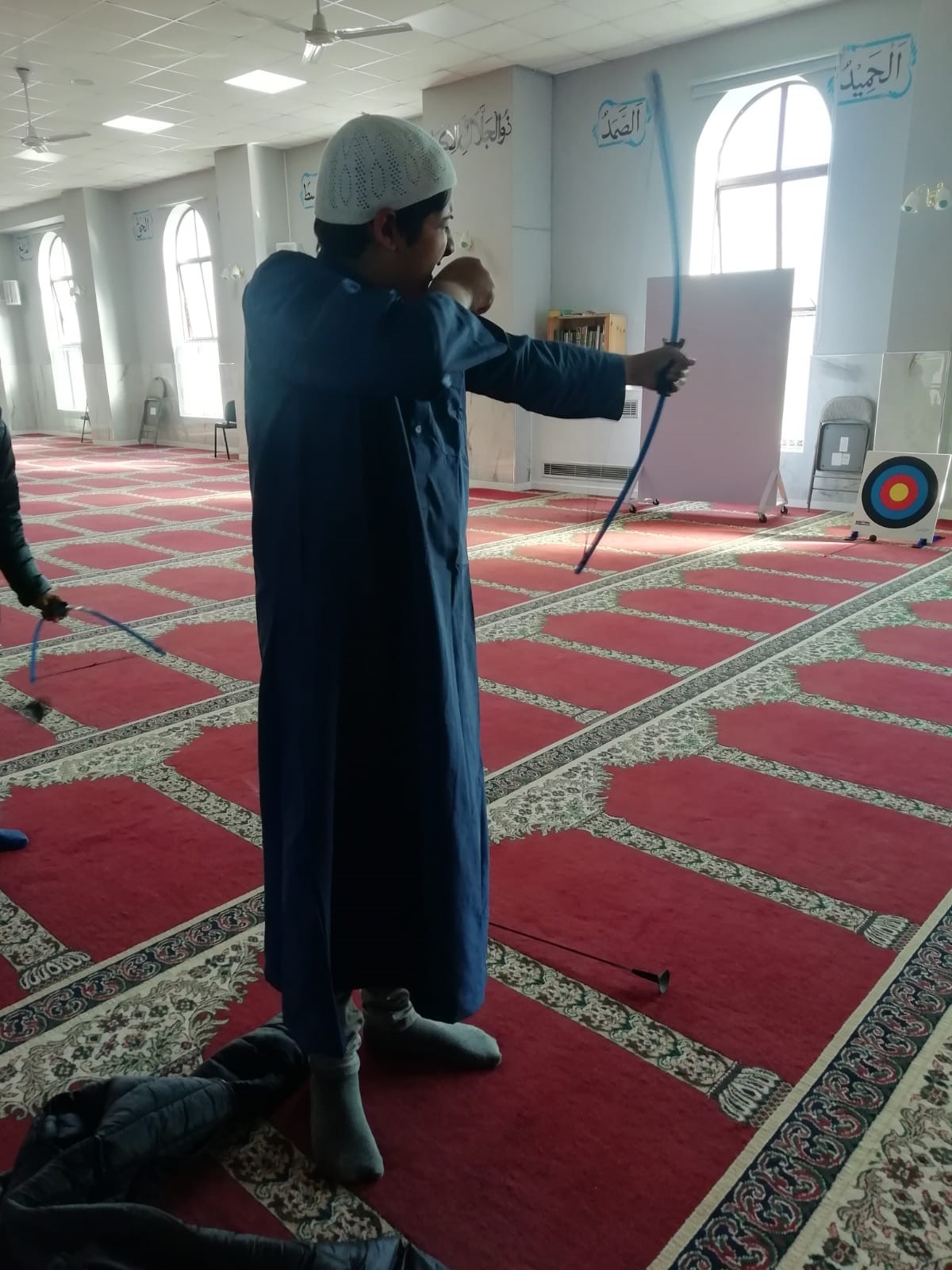 Boy doing soft archery in the mosque