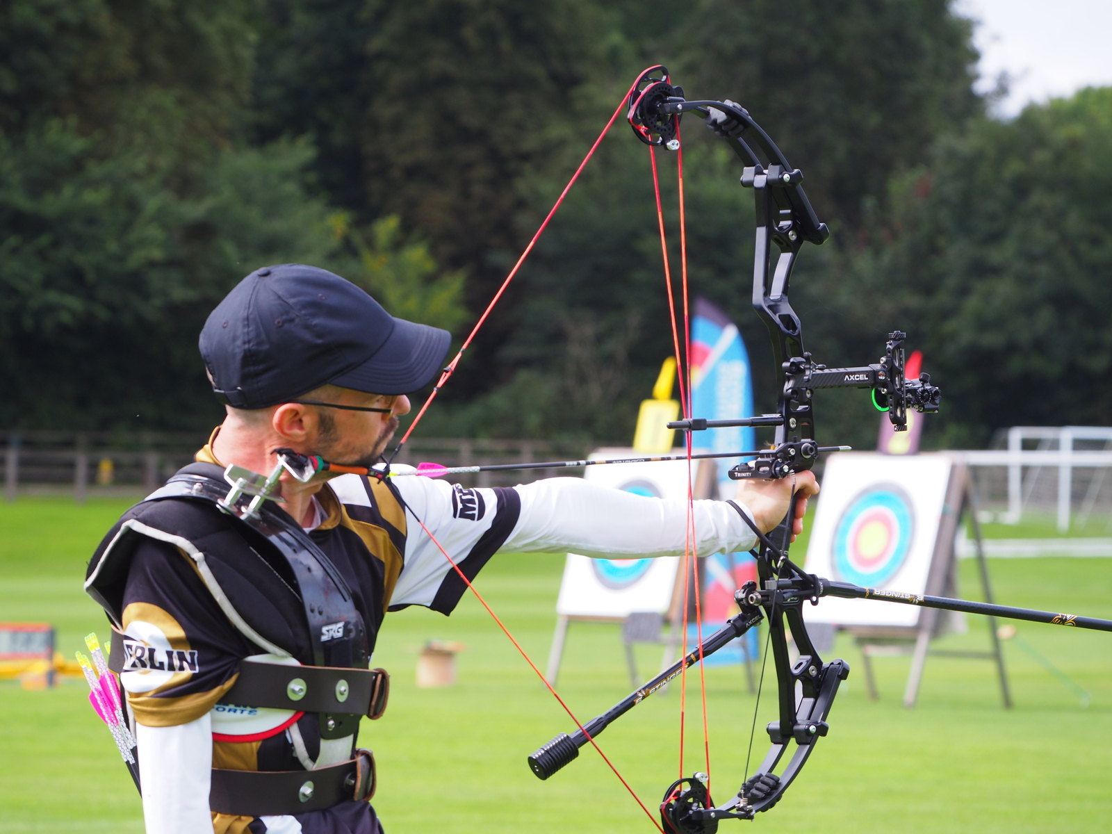 Archer using adaptive equipment to shoot