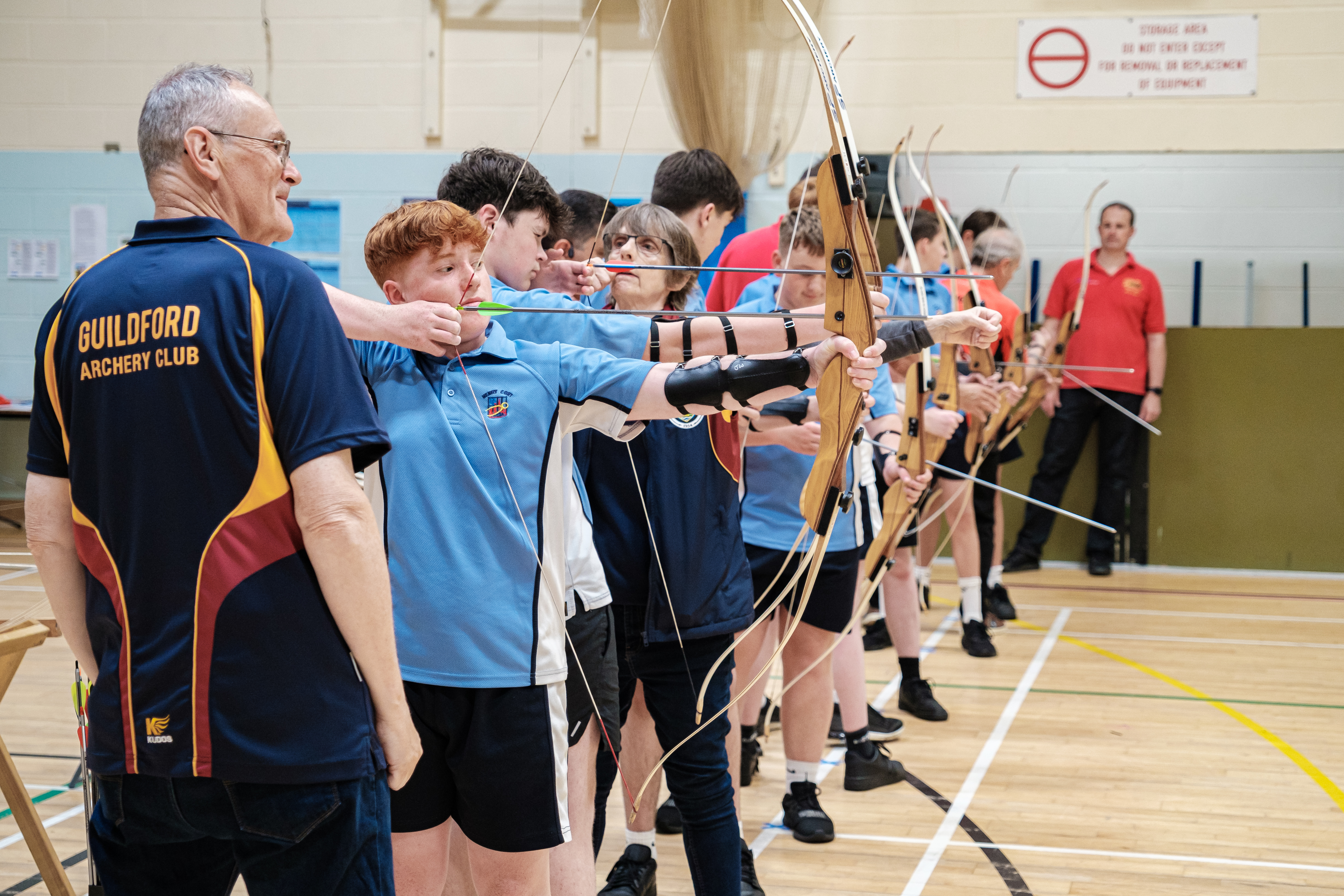 Archers and coaches on the shooting line